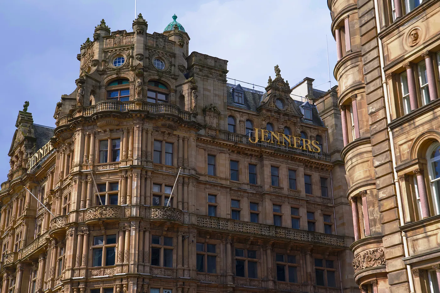 The top corner of the Jenners building opposite the Scott monument.