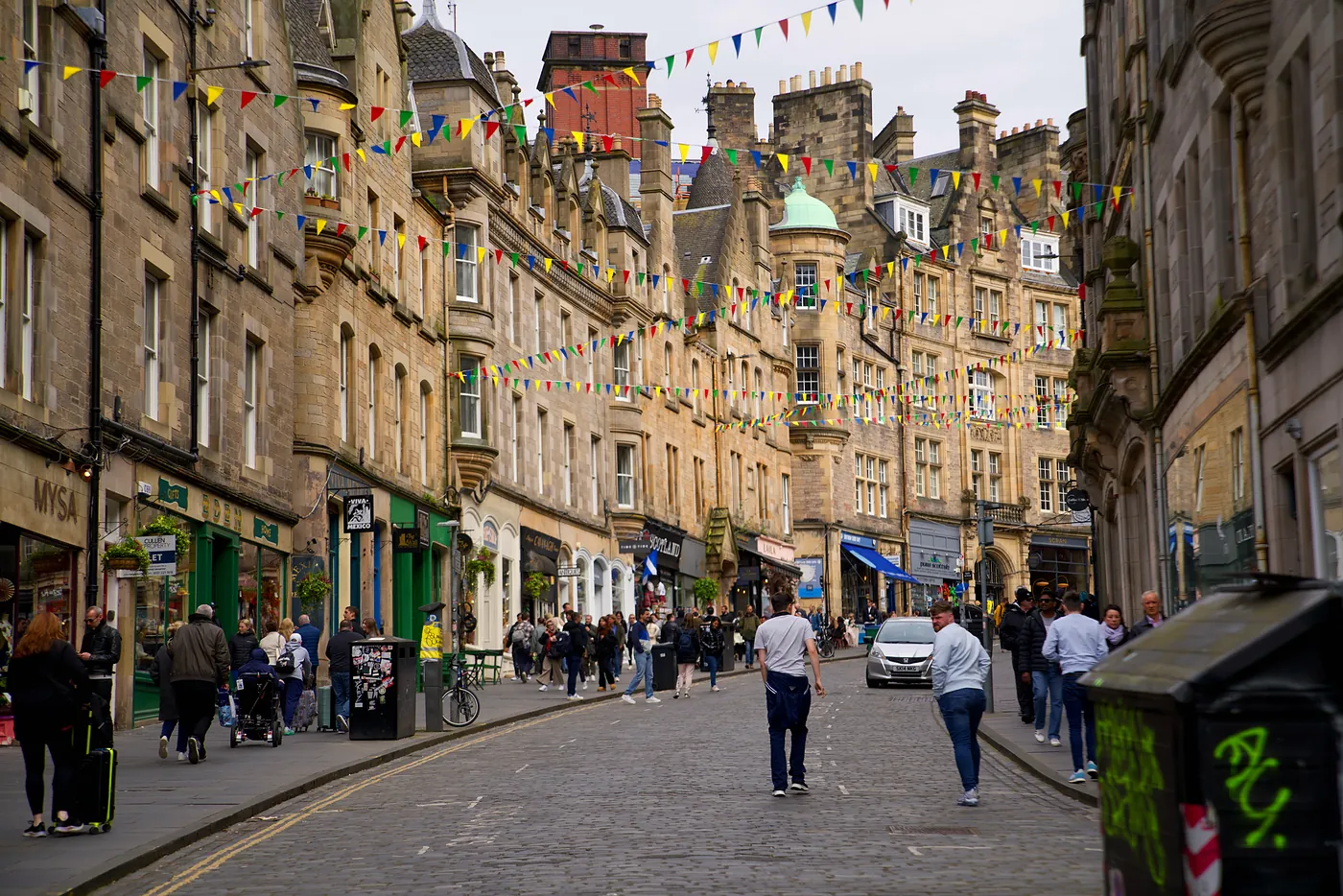 A view of Cockburn Street's buildings and festive flags.