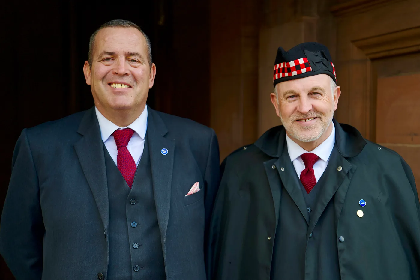 Two hotel employees, one with a glengarry bonet.