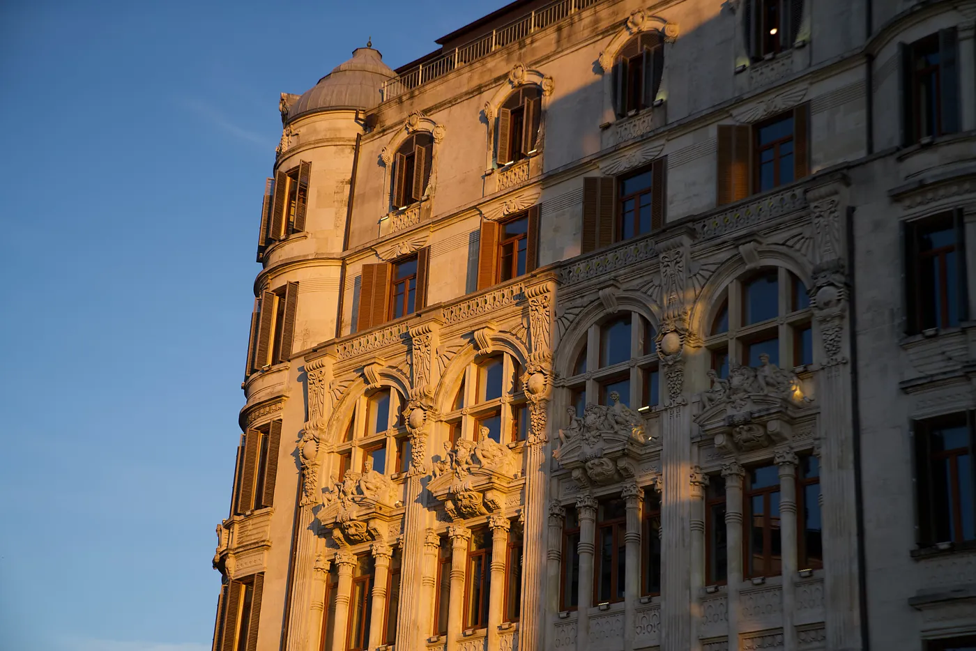 The sun caressing an old building's façade.