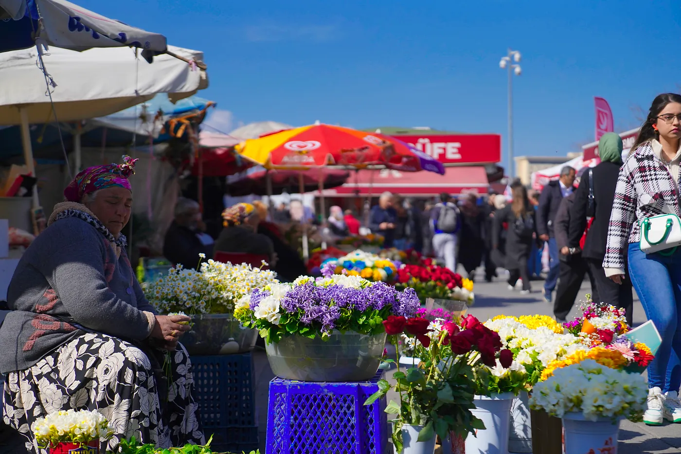 A woman selling flowers to passerbys near one of Kadıköy's Bosphorus-bound ferry terminals.