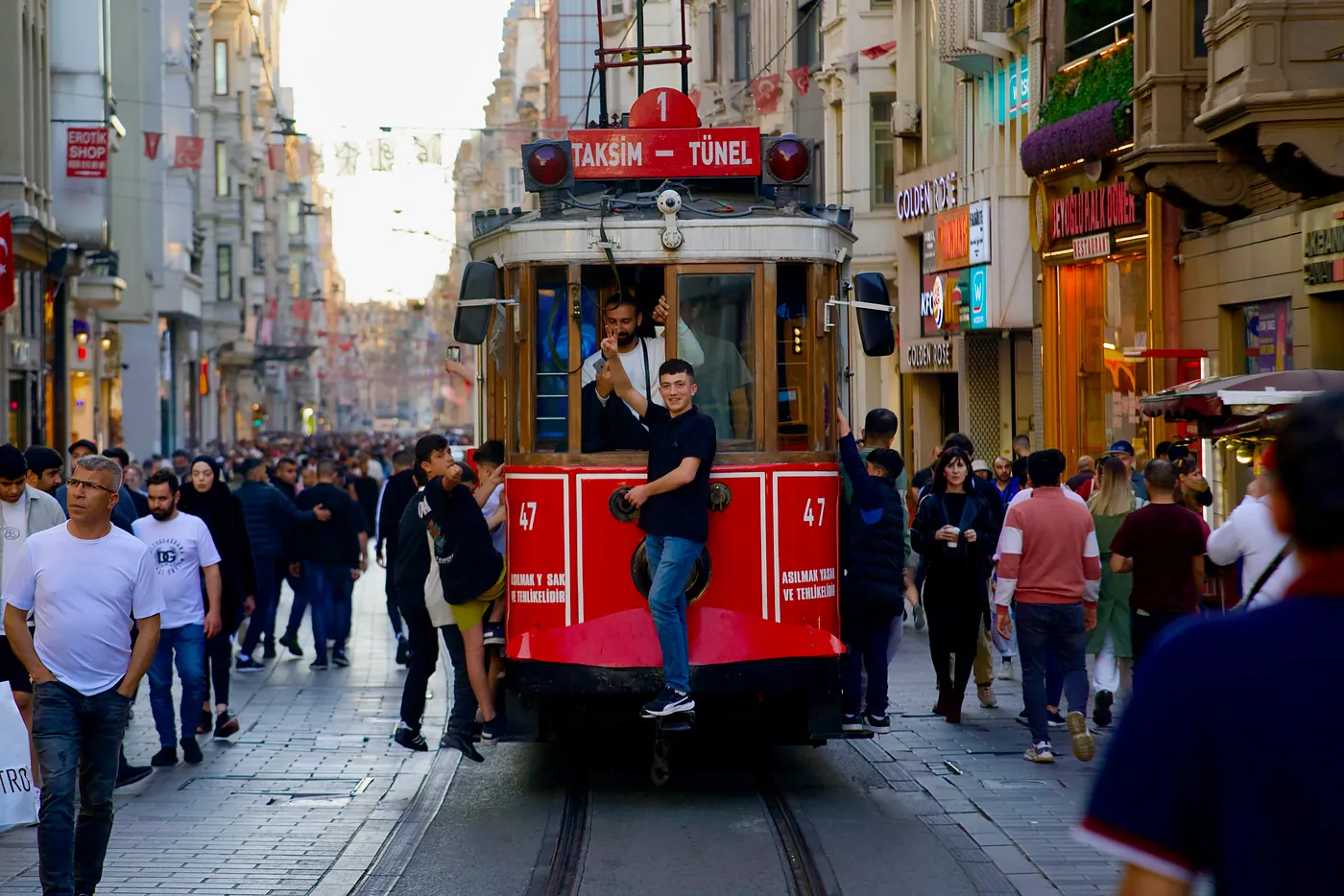 Young boys hitching a ride on one of Taksim's street trams.