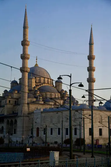 The domes and minarets of the New Mosque in Eminönü lit by evening sun, Istanbul